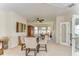 Cozy living area features a round table with chairs, a china cabinet and ample natural light at 6201 Marbella Blvd, Apollo Beach, FL 33572