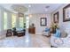 Sitting area boasts large windows, tile floors, and elegant furnishings, enhancing the room's appeal at 6201 Marbella Blvd, Apollo Beach, FL 33572