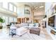 Open-concept living space featuring a plush sectional, stylish decor, and seamless flow throughout at 6201 Marbella Blvd, Apollo Beach, FL 33572