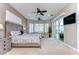Comfortable main bedroom featuring a large bed, sitting area, carpet, and sliding glass doors at 6201 Marbella Blvd, Apollo Beach, FL 33572