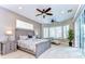 Main bedroom with neutral colors, carpet, large bed, and windows with plantation shutters at 6201 Marbella Blvd, Apollo Beach, FL 33572