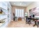 Bright office with built-in bookshelves, a shuttered window, and a modern desk setup at 6201 Marbella Blvd, Apollo Beach, FL 33572
