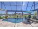 Screened pool with water features, table seating and views of the canal and neighboring properties at 6201 Marbella Blvd, Apollo Beach, FL 33572