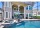 Screened pool with jacuzzi, umbrella, patio table and chairs, grill and view of the home at 6201 Marbella Blvd, Apollo Beach, FL 33572