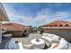 Comfortable roof deck with curved sofas, tables, red clay tile roofs, and neighborhood views at 6201 Marbella Blvd, Apollo Beach, FL 33572