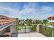 Open roof deck with black metal railing, neighborhood views, beautiful landscaping and beach views at 6201 Marbella Blvd, Apollo Beach, FL 33572