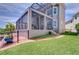 Screened lanai overlooking the lush backyard and waterfront at 6201 Marbella Blvd, Apollo Beach, FL 33572