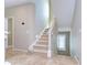 Carpeted staircase with decorative lighting, neutral walls, tile floor and a window with shutter at 6201 Marbella Blvd, Apollo Beach, FL 33572