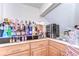 Wet bar featuring wood cabinets, stone countertops, sink, and beverage refrigeration at 6201 Marbella Blvd, Apollo Beach, FL 33572