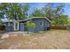 A charming backyard featuring a freshly painted exterior with a small tree accenting the outdoor space at 6225 76Th N Ave, Pinellas Park, FL 33781