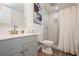 Clean bathroom with vanity, toilet, and tiled walk-in shower with curtain at 6225 76Th N Ave, Pinellas Park, FL 33781