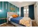 This bedroom features modern accents with a queen-sized bed and plush grey headboard at 6225 76Th N Ave, Pinellas Park, FL 33781
