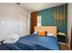 Bedroom features a queen size bed, a Honeycomb accent wall, and a sliding door closet at 6225 76Th N Ave, Pinellas Park, FL 33781