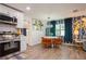 Bright dining area featuring a round table, orange chairs, and accent wallpaper at 6225 76Th N Ave, Pinellas Park, FL 33781