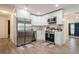Modern kitchen with stainless steel appliances, white cabinetry, and hardwood flooring at 6225 76Th N Ave, Pinellas Park, FL 33781