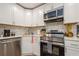 Modern kitchen with white cabinets, stainless steel appliances, and stylish backsplash at 6225 76Th N Ave, Pinellas Park, FL 33781