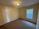 Bedroom with neutral carpet, a window, and a double door closet at 7326 Cutwater Ln, Wesley Chapel, FL 33545