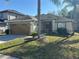 Attractive single-story home with a two-car garage, mature landscaping, and a welcoming facade at 7326 Cutwater Ln, Wesley Chapel, FL 33545