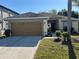 Charming single-story home featuring a two-car garage and well-maintained front yard at 7326 Cutwater Ln, Wesley Chapel, FL 33545