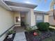 Inviting front porch with decorative planters and a textured exterior at 7326 Cutwater Ln, Wesley Chapel, FL 33545