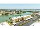 An aerial view highlighting the waterfront condo community, lush landscaping, and ample parking at 7465 Bay Island S Dr # 316, South Pasadena, FL 33707