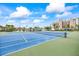 Exterior view featuring tennis courts and landscaping at the condo community at 7465 Bay Island S Dr # 316, South Pasadena, FL 33707