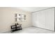 Bedroom with tile floor, large window, and closet with folding doors at 7701 Starkey Rd # 445, Seminole, FL 33777