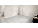 Bright bedroom with ceramic tile floors, neutral walls, and access to a bathroom at 7701 Starkey Rd # 445, Seminole, FL 33777