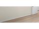 Bedroom with wood-look floor, neutral walls, and white trim at 7701 Starkey Rd # 445, Seminole, FL 33777