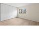 Bedroom with wood-look floor, large window, and spacious closet with folding doors at 7701 Starkey Rd # 445, Seminole, FL 33777