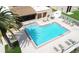 Community pool with brick paver deck, lounge chairs, and shaded seating areas at 7701 Starkey Rd # 445, Seminole, FL 33777