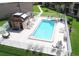 Community pool with brick paver deck, lounge chairs, shaded seating areas, and restroom facilities at 7701 Starkey Rd # 445, Seminole, FL 33777