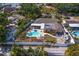 Aerial view of a fenced in yard with an in-ground pool, seating, and patio area at 843 37Th Ne Ave, St Petersburg, FL 33704