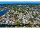 Overhead view of waterfront homes with pools and private docks leading to scenic canals, lush green trees, and more at 843 37Th Ne Ave, St Petersburg, FL 33704