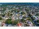 Aerial view showcases neighborhood homes, some with backyard pools, near winding canals and lush green spaces at 843 37Th Ne Ave, St Petersburg, FL 33704