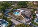 Aerial view of a home with a fenced yard, covered patio, pool and spa, boat, and mature tropical landscaping at 843 37Th Ne Ave, St Petersburg, FL 33704