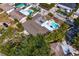 Aerial view showcases a home with a pool, patio, and fenced in yard with tropical foliage at 843 37Th Ne Ave, St Petersburg, FL 33704