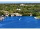 Aerial shot of a scenic waterway with boats cruising near docks and waterfront properties surrounded by lush trees at 843 37Th Ne Ave, St Petersburg, FL 33704