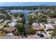 Aerial view of waterfront houses along a canal leading to the city with lush greenery and private boat docks at 843 37Th Ne Ave, St Petersburg, FL 33704
