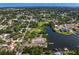 Expansive aerial view of a residential neighborhood nestled among mature trees with a peaceful waterfront at 843 37Th Ne Ave, St Petersburg, FL 33704
