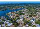 Aerial view of waterfront homes with pools and docks with easy access to canals, green fairways and a cityscape at 843 37Th Ne Ave, St Petersburg, FL 33704