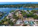 Waterfront property aerial view featuring a private pool, lush landscaping, and stunning bay views with the city skyline on the horizon at 843 37Th Ne Ave, St Petersburg, FL 33704