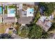 Aerial view showcasing a collection of in-ground pools, patios, and lush greenery at 843 37Th Ne Ave, St Petersburg, FL 33704