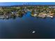 Scenic aerial view of waterfront homes lining the canal with a boat navigating the tranquil waters towards the city skyline at 843 37Th Ne Ave, St Petersburg, FL 33704