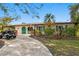 Inviting single-story home with a circular driveway and eye-catching turquoise door at 843 37Th Ne Ave, St Petersburg, FL 33704