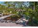 Inviting home with a circular driveway, lush landscaping, a mature tree, and classic curb appeal at 843 37Th Ne Ave, St Petersburg, FL 33704