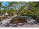 Home with a circular driveway framed by a mature tree, manicured landscaping, and quaint curb appeal at 843 37Th Ne Ave, St Petersburg, FL 33704