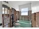 Bathroom featuring exposed framework, a window, and a pastel-green bathtub and toilet, awaiting renovation at 844 Bay Point Dr, Madeira Beach, FL 33708