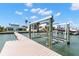 Private boat dock with boat lift, and clear waterway access, ready for boating at 844 Bay Point Dr, Madeira Beach, FL 33708