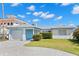 Charming single-story home with a well-manicured front lawn and a spacious two-car garage at 844 Bay Point Dr, Madeira Beach, FL 33708